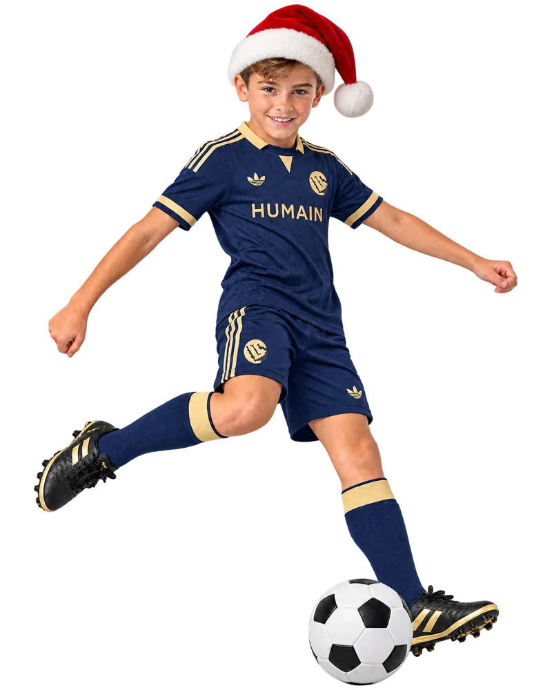 Boy aged 12 kicking a football, wearing a kids football kit – ages 10 to 13