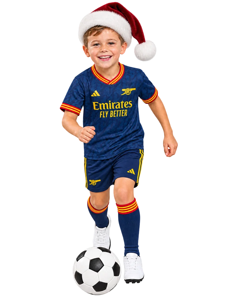 Boy aged 6 dribbling a football, wearing a kids football kit – ages 5 to 8