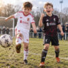 Liverpool Away and Third Gift Pack Kids Football Kits 26/27 - boys wearing kids football kits on UK pitch
