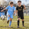 Manchester City Home and Away Gift Pack Kids Football Kits 26/27 - boys wearing kids football kits on UK pitch