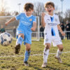 Manchester City Home and Third Gift Pack Kids Football Kits 26/27 - boys wearing kids football kits on UK pitch