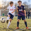 Tottenham Hotspur Home and Away Gift Pack Kids Football Kits 26/27 - boys wearing kids football kits on UK pitch